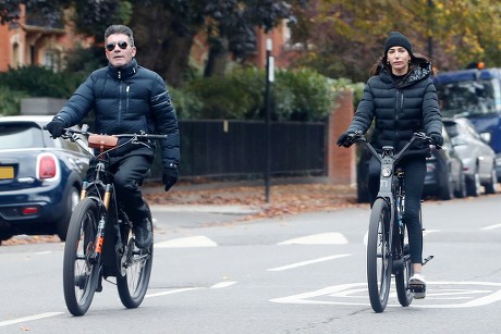 Exclusive - Simon Cowell and Lauren Silverman cycling in West London, UK - 03 Nov 2021