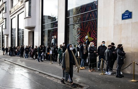 Queue of shoppers outside Louis Vuitton store on Champs Elysees in