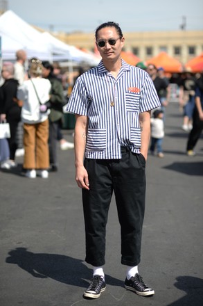 Greg Sato, wearing Garrett Leight sunglasses, Finery x Woon uniform shirt, Finery pants, and Converse x 7 Moncler Fragment