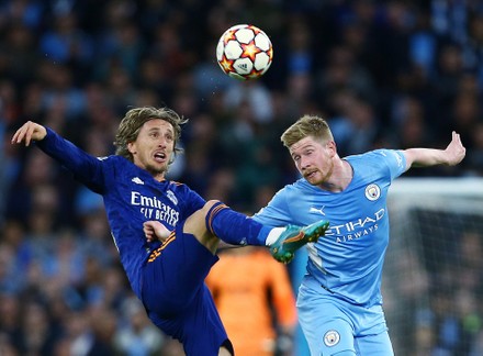 Real Madrid's Luka Modric, right, heads the ball past Manchester