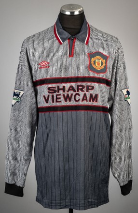 An infamous 'invisible' grey football shirt worn by Manchester United legend Eric Cantona has today sold for £12,400.

The club played in the ill-advised strip for away games during the 1995-96 Premier League season. But they ditched the jersey after losing four out of five games in it.

Things came to a head during an away game at Southampton in April 1996 where the team went in at half-time 3-0 down. The players complained the grey shirts made their teammates blend in with the crows and they couldn't pick each other out on the pitch. 

Sir Alex Ferguson ordered his players to change into a blue and white coloured strip, although they still lost the match 3-1.

The long-sleeved XXL-sized Umbro shirt, with Cantona's name and number seven on the back, went under the hammer with Graham Budd Auctions, of London. Also in the sale, a pair of Umbro XAI boots Wayne Rooney wore when he scored his first Premier League goal as a 16 year old fetched £10,540.