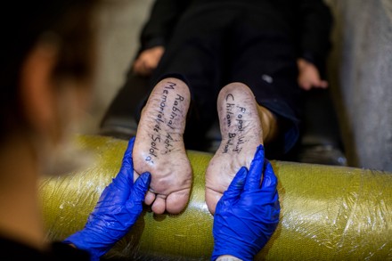 Tattooed feet of Guatemalan indigenous artist Benvenuto Chavajay seen at  the end of the performance entitled 