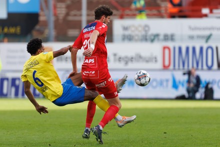 Kortrijk s Didier Lamkel Ze and Westerlo s Bryan Reynolds fight for the  ball during a