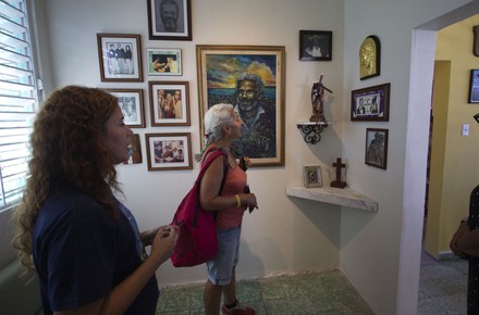 Fans take photographs next to a sculpture by Puerto Rican artist