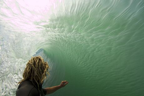Surfer takes photographs inside wave roll, Australia - 2010