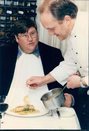 Chef Alex Aitken Serving Food Critic Charles Campion A Sausage With Truffles Meal.