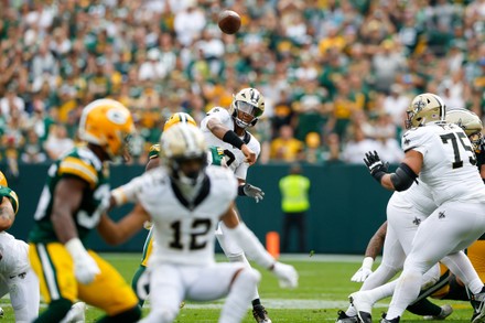 Green Bay, Wisconsin, USA. 24th Sep, 2023. Green Bay Packers linebacker  Quay Walker (7) and safety Rudy Ford (20) tackle New Orleans Saints running  back Kendre Miller (25) during the NFL football