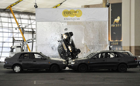 Stuntman Rocky Taylor breaks the Guinness World Record for largest breakaway glass structure smashed by a car, O2 Arena, London, Britain - 13 Sep 2011