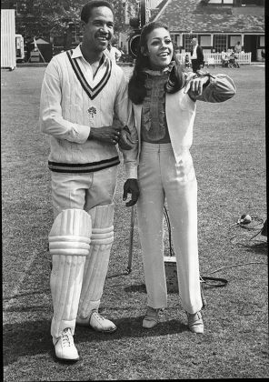 West Indian Skipper Sir Gary Sobers Who Now Skippers Nottinghamshire Is Seen In His New Role As A Film Actor. He Is Pictured During The Shooting Of Scenes For 'two Gentlemen Sharing At Westminster School Cricket Ground. With Him Is Esther Anderson O