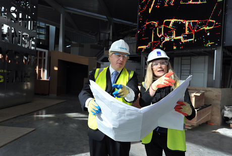 London Mayor Boris Johnson is shown designs by designer Abby Coombs during a visit the Crystal visitors centre by the Emirates Cable Car in East London, on the final week of his Mayoral Campaign