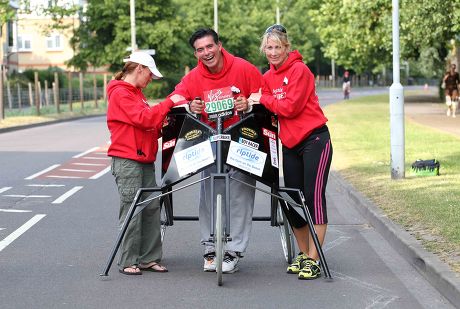 Eddie Kidd With His Wife Sammi Kidd (baseball Cap) And Friend And Helper Susan Taylor As They Approach The Eleven Mile Marker On The Route Of The London Marathon.