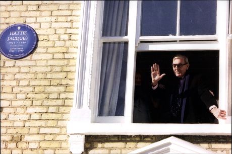 Actor Eric Sykes Waves From The Window Of The Home Where Actress Hattie Jacques Lived Blue Plaque Visible.