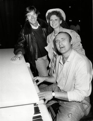 Phil Collins Pop Star At Piano With Singer-actress Bonny Langford And Actor Nigel Havers All At Theatre Royal Drury Lane For Terry Thomas Benefit Concert 1989.