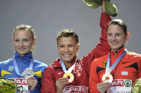 Turkey's Gulcan Mingir received her gold medal for women's 3000 m steeplechase, Ukraine's Svitlana Shmidt (L) was second, Antje Moeldner-Schmidt (R) took bronze