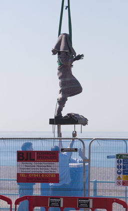 The new £50,000 bronze statue of Olympic Gold medalist Steve Ovett is lowered onto it's plinth on Brighton seafront, East Sussex, Britain - 23 Jul 2012