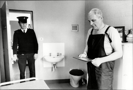 Wayland Prison Norfolk; A Prison Officer Looks In On Inmate Richard Page In His Single Cell 1985.