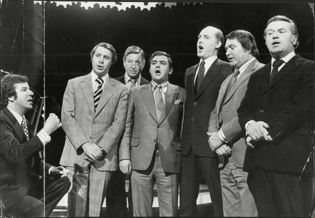 Television Presenter Russell Harty With Itn Newsreaders Carol Singing. L-r Russell Harty Leonard Parkin Sandy Gall Robert Southgate Gordon Honeycome Ivor Mills And Reginald Bosanquet Russell Harty (5 September 1934 A 8 June 1988) Was A British Televi