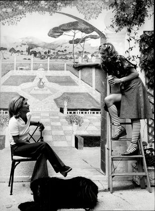Sue Lloyd Actress Painting Mural On Her Garden Wall With Neighbour Jean Hedley Wife Of Actor Jack Hedley (not Shown) And Dog 1976.