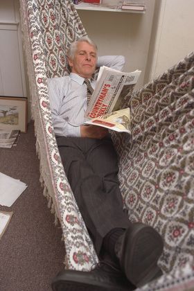 Robin Hanbury-tenison Explorer And Chief Executive Of The British Field Sports Society At Their Kennington South London Hq Today Pix Include Him On His Southern American Hammock Behind His Desk As He Answers The Phone.