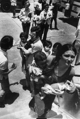 Vietnamese Orphans Board Our Aircraft At Tan Son Nhut Air Base. Operation Mercy Airlift - Chartered By The Daily Mail Brian Freemantle Daily Mail Journalist Is Centre Holding Child And Looking Left.