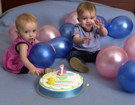 Saffron Drewitt-barlow (l) And Aspen Drewitt-barlow The Children Of Barrie Drewitt And Tony Barlow. In Sweden Celebrating The Twins' First Birthday With A Cake And Balloons. The Homosexual Fathers Have Just Announced That They Are To Launch A Ii100