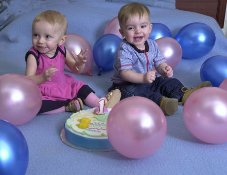 Saffron Drewitt-barlow (l) And Aspen Drewitt-barlow The Children Of Barrie Drewitt And Tony Barlow. In Sweden Celebrating The Twins' First Birthday With A Cake And Balloons. The Homosexual Fathers Have Just Announced That They Are To Launch A Ii100