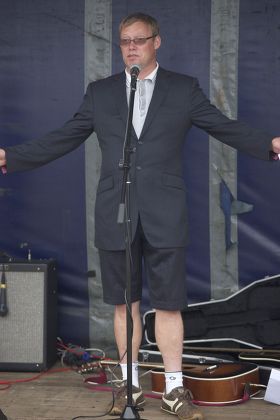 Ricky Groves raises the flag for West Bay Day in Dorset, Britain - 04 Aug 2013