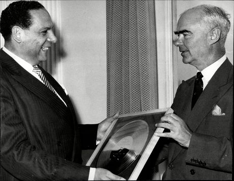 Band Leader Edmundo Ros Receives A Golden Disc From Sir Edward Lewis The Chairman Of Decca Records.