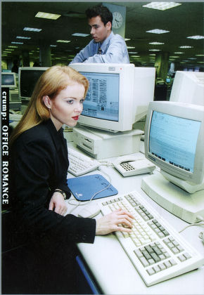 Woman Office Worker At Computer While Male Colleague Looks On For Feature On Office Romance- Posed By Models 1995. **image Was Used 03/04/2000 P.52 To Illustrate An American Sitcom Entitled 'oh Baby'. The Female Model In The Picture Was Incorrectly