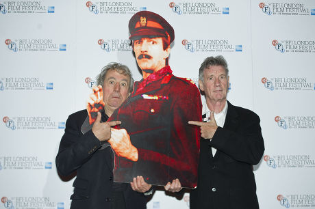 Terry Jones And Michael Palin At The Screening Of A Liar's Autobiography Empire Cinema Leicester Square London. They Are Holding A Cardboard Cut Out Of The Author Graham Chapman.