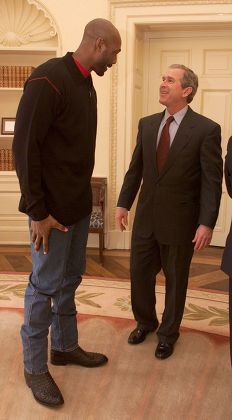 U.S. President George W. Bush talks with Karl Malone of the Utah Jazz in the Oval Office of the White House  Washington America on  February 9, 2001