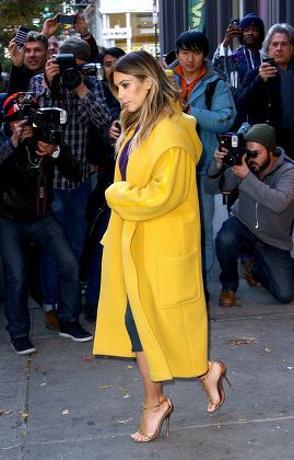 Kim Kardashian wearing a coat by Max Mara and a mustard yellow