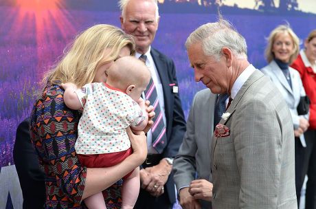 Prince Charles meets Emylia Hall, 35, from Bristol, along with her son Calvin Jack, 5 months, during a visit to Castle Cary Railway Station