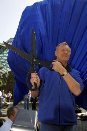 A Man Holding Giant Scissors by Stocksy Contributor Evgeniy