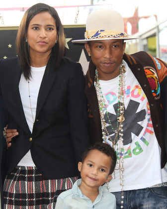 Pharrell Williams supported by wife Helen and son Rocket as he