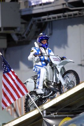 ROBBIE KNIEVEL JUMPING OVER SEVEN VINTAGE AIRCRAFT ON A MOTORCYCLE ABOARD THE FLIGHTDECK OF THE USS INTREPID, SEA, AIR AND SPACE MUSEUM, NEW YORK, AMERICA - 31 JUL 2004