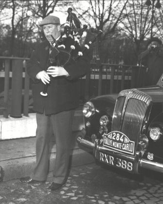 Monte Carlo Rally 1958. Major Donald Macleod Who Is Driving A Daimler Has A Tune Of Of His Bagpipes. Box 0600 01072015 00439a.jpg.