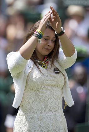 Wimbledon Tennis Championships 2014; Marion Bartoli Sheds A Tear As She Returns To The Scene Of Her Victory In 2013 With Elle Robus-miller A Young Tennis Player From The Elena Baltacha Academy Of Tennis Credit Image: Graham Chadwick/daily Mail/solo S