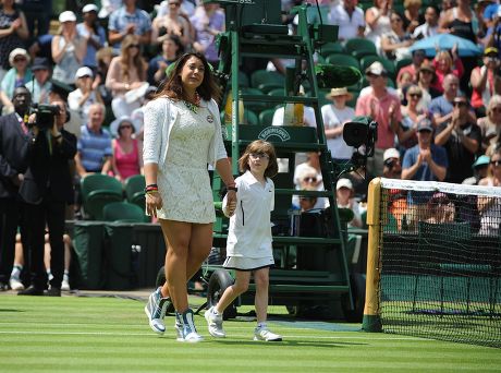 Wimbledon Tennis Championships 2014; Marion Bartoli Sheds A Tear As She Returns To The Scene Of Her Victory In 2013 With Elle Robus-miller A Young Tennis Player From The Elena Baltacha Academy Of Tennis Credit Image: Graham Chadwick/daily Mail/solo S