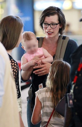 Milla Jovovich and family at Cape Town Airport, South Africa - 10 Dec 2015
