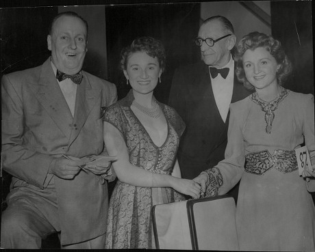 Actress Avril Angers Commentator Barrington Dalby (glasses) And Comedian Billy Howard Congratulate Maria Alfieri Winner Of The 1952 Miss Wimpey Beauty Contest. For Full Caption See Version. Box 680 326041643 A.jpg.
