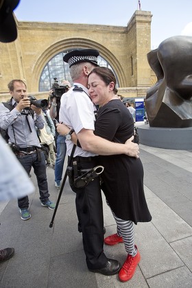 Walk Together For Peace - 7/7 London Bombings Survivor Gill Hicks Is Hugged By Pc Andy Maxwell (who May Have Rescued Her) At King's Cross. Faith Leaders From Muslim Jewish And Christian Faiths Walked With A Floral Tribute From King's Cross To Tavis