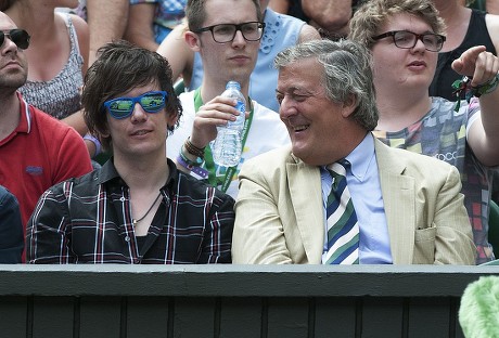 Stephen Fry Watches The Tennis With His Partner Elliott Spencer. Day 8: Maria Sharapova V Coco Vandeweghe Wimbledon 2015 Tennis Championships Wimbledon London. Picture: Murray Sanders/daily Mail.