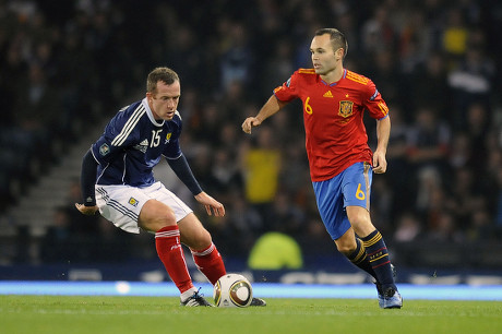 Football - Euro 2012 Qualifying - Scotland vs Spain Andres Iniesta (Spain) and Charlie Adam (Scotland) at Hampden Park