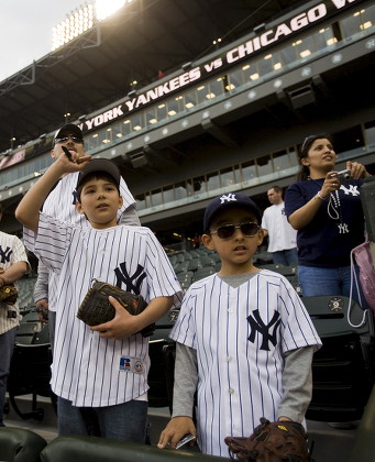 Henry Garza (rear) Stands with His Son Ricky Garza (l) and Stepson Damien Marquez (r) As They Try to Get the Attention of New York Yankee Players During Warmups Before the Start of Their Major League Baseball Game Against the Chicago White Sox at U S Cellular Field in Chicago Illinois Usa 22 April 2008 United States Chicago