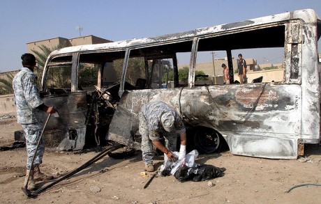Iraqi Policemen Inspect Burnt Bus Site Editorial Stock Photo - Stock
