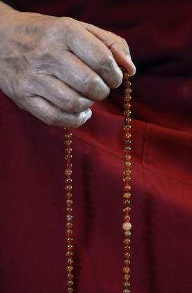 Dalai lama deals prayer beads