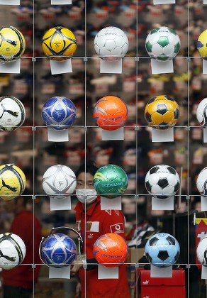 Footballs or Soccer Balls on Display in a Sports Store. Editorial