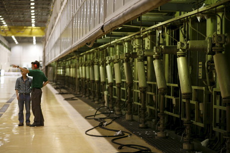 Two Workers Stand Beside One Gigantic Editorial Stock Photo - Stock ...