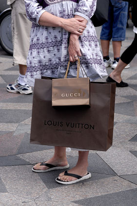 CONSUMERS with LOUIS VUITTON SHOPPING BAG Editorial Stock Photo